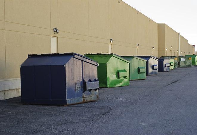 portable, green construction dumpsters serving as a container for scrap materials in Andover